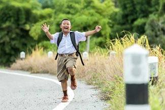 little boy skipping on road.jpg